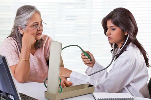 Doctor measuring blood pressure in hypertension